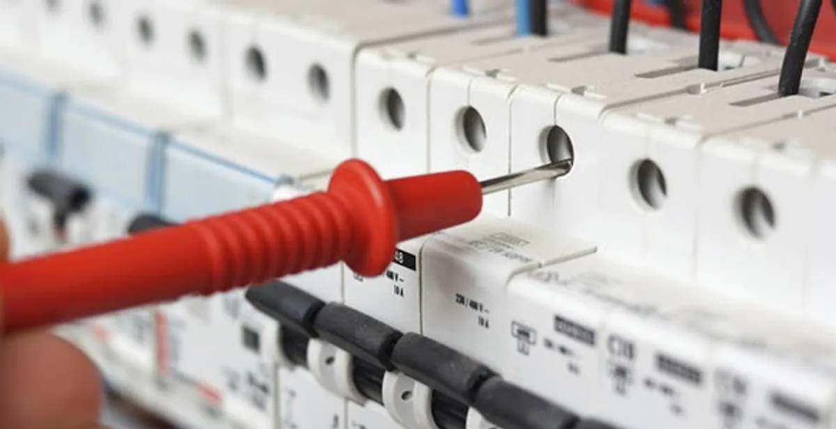 Electrical contractor testing circuit breakers during electrical repair in Shawnee Mission, KS
