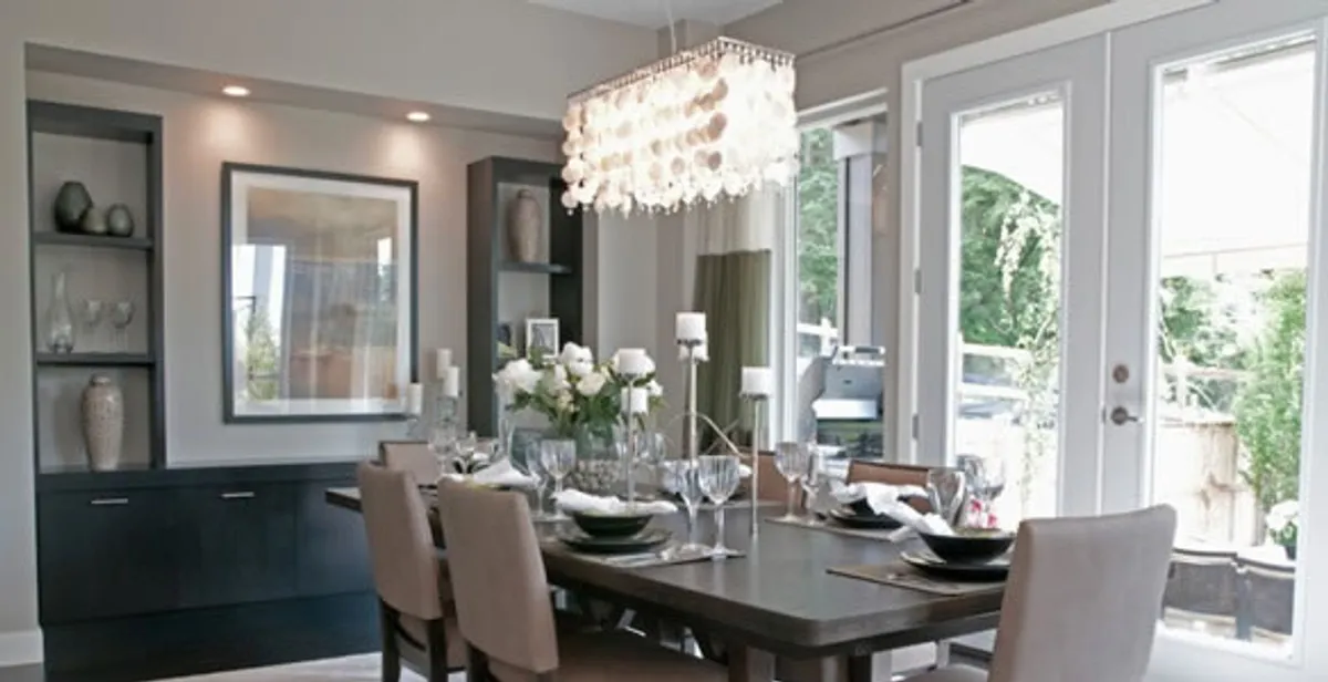 Elegant dining room chandelier installation above table in Overland Park, KS