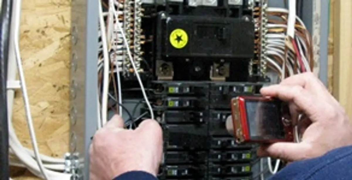 Home electrical inspection of circuit breaker panel by licensed electrician in Overland Park, KS