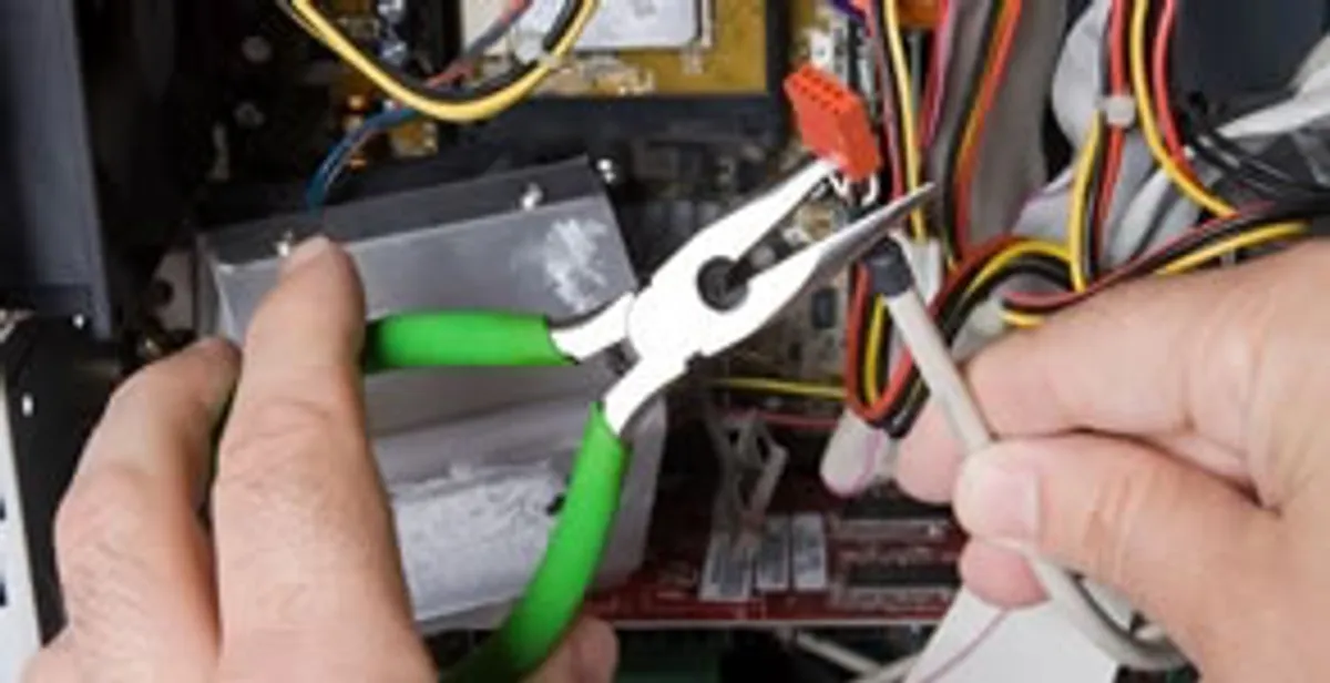 Licensed electrical contractor performing electrical repair with tools in Shawnee, KS