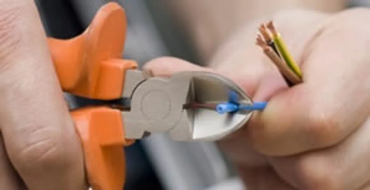 professional electrical services showing precise wire cutting by licensed electricians in Overland Park, KS