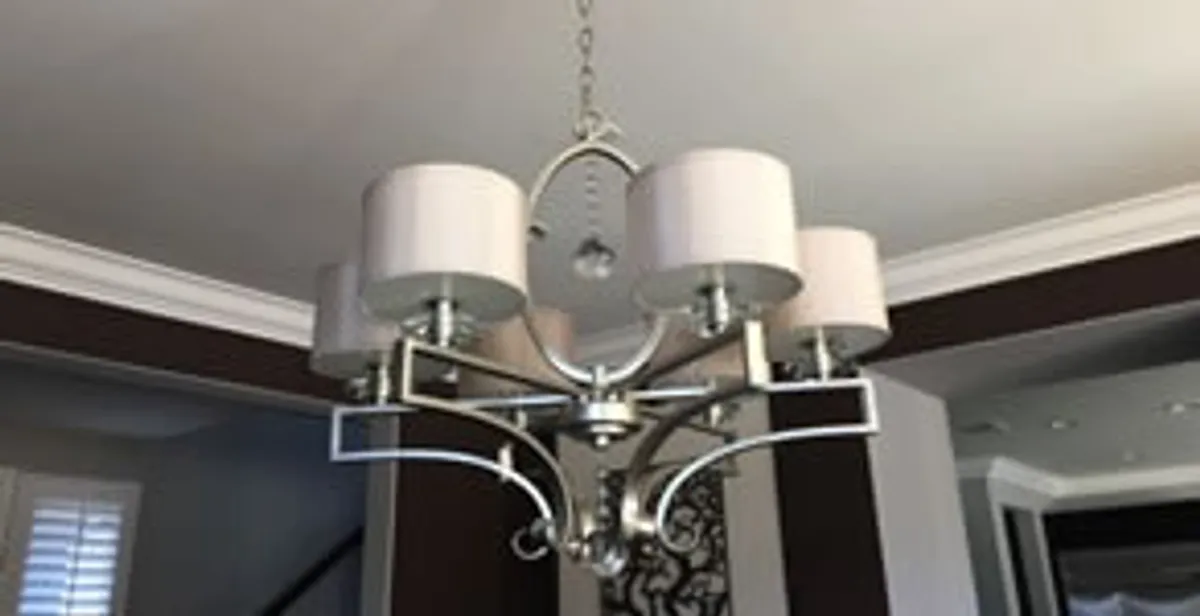 Modern chandelier installation with multiple light fixtures in Overland Park, KS
